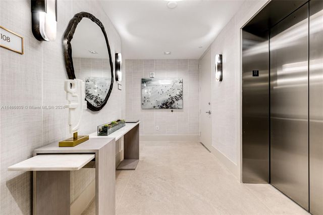 a living room with furniture and large windows