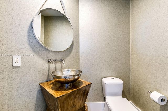 a living room with furniture a table and a large window