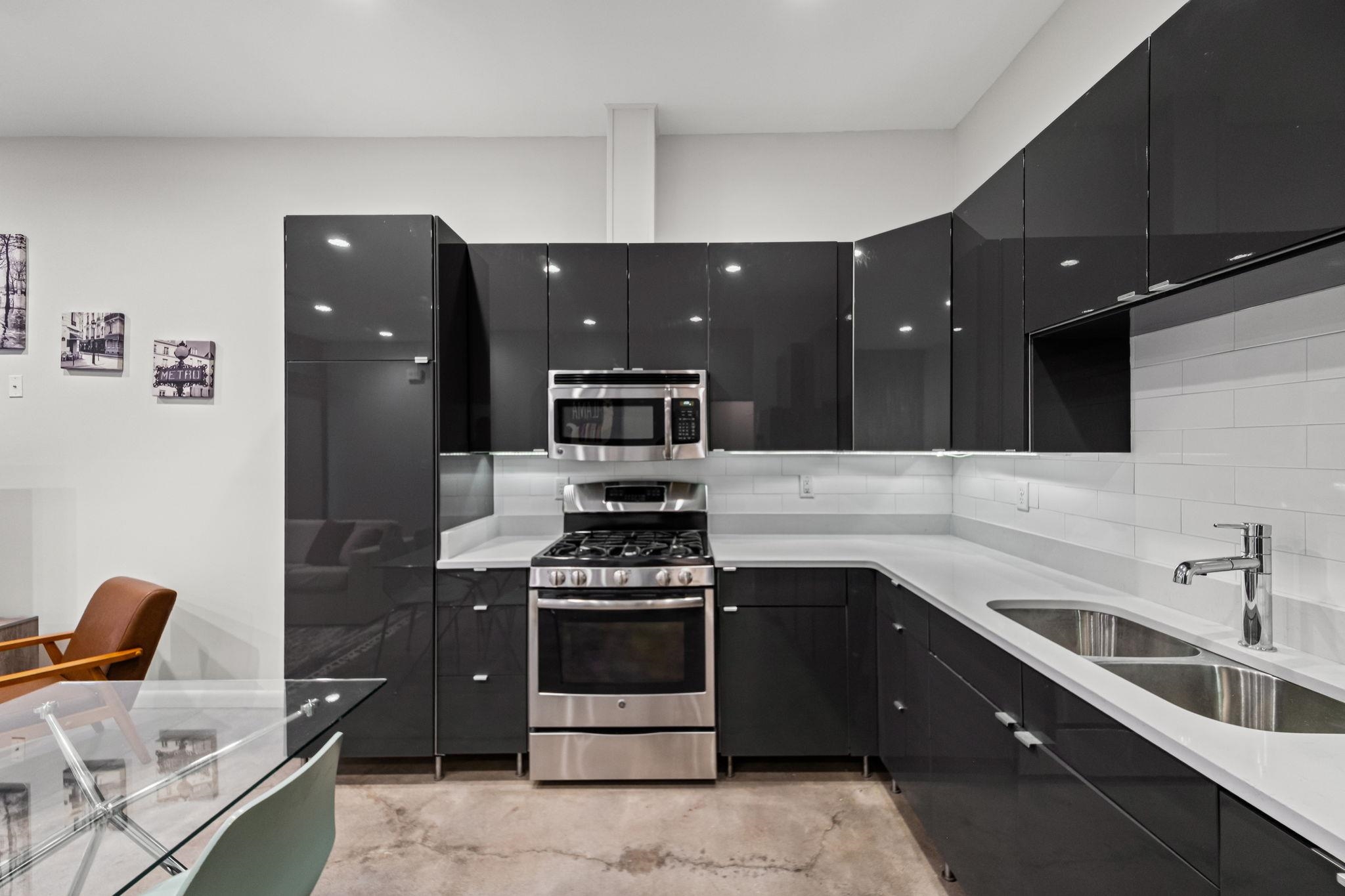 448 Tennessee Street Memphis, TN 38103 - Photo 29 of 39 a kitchen with a sink and white cabinets