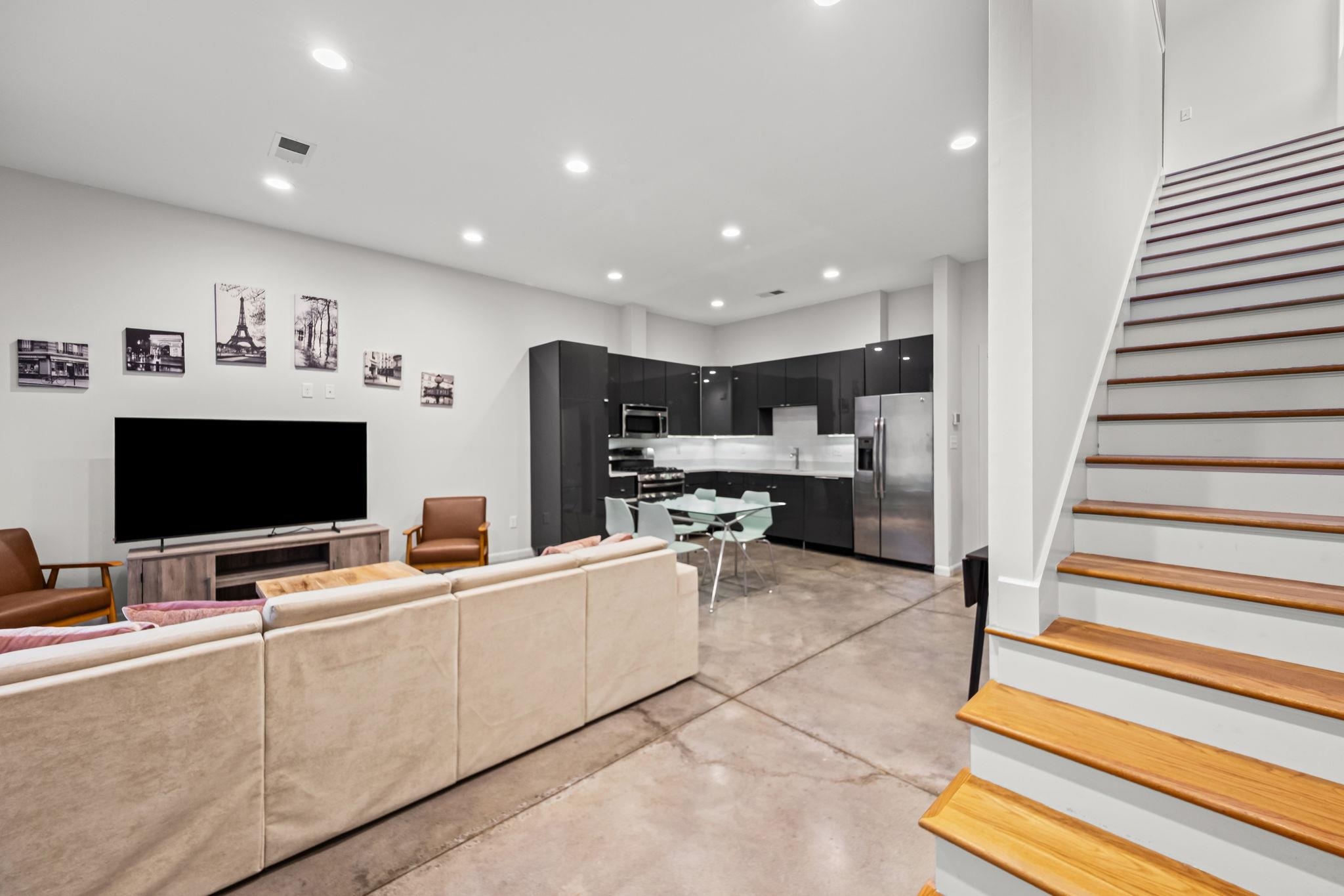 448 Tennessee Street Memphis, TN 38103 - Photo 37 of 39 a living room with stainless steel appliances kitchen island granite countertop a sink and a refrigerator