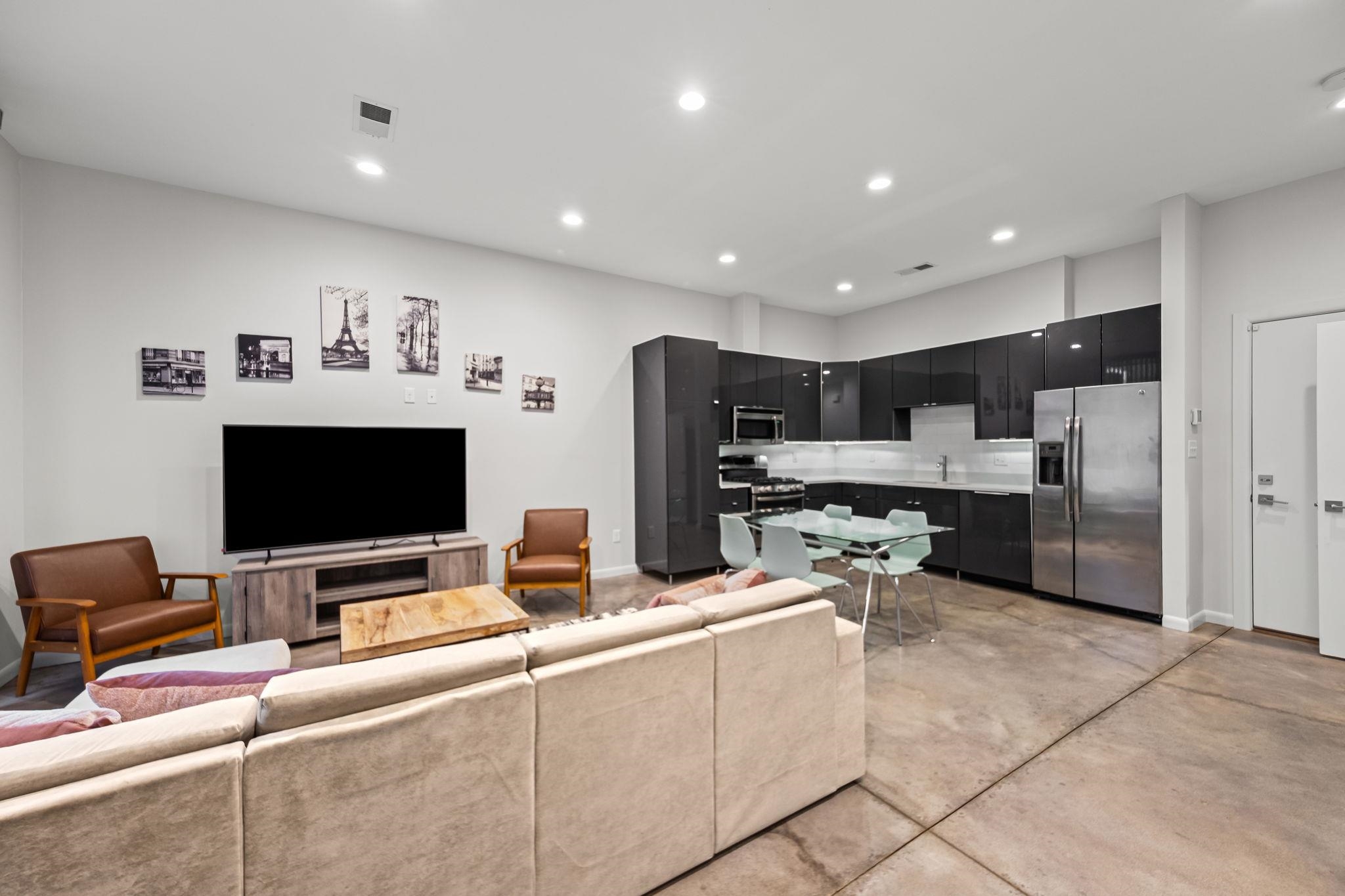 448 Tennessee Street Memphis, TN 38103 - Photo 38 of 39 a living room with stainless steel appliances kitchen island granite countertop a refrigerator and a stove top oven