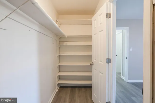 a view of walk in closet with empty racks