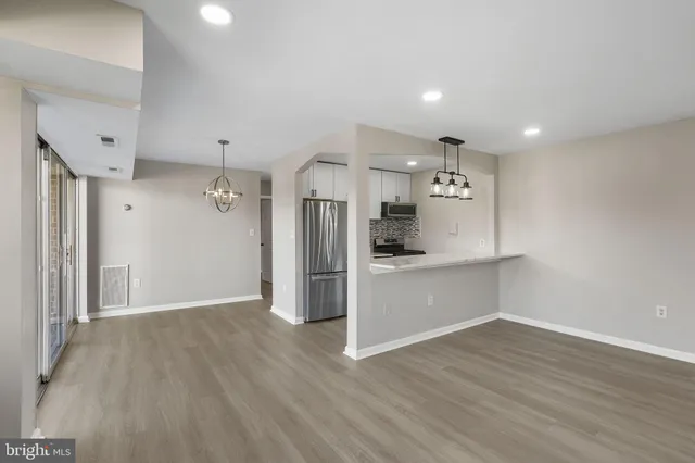 a view of a kitchen with wooden floor