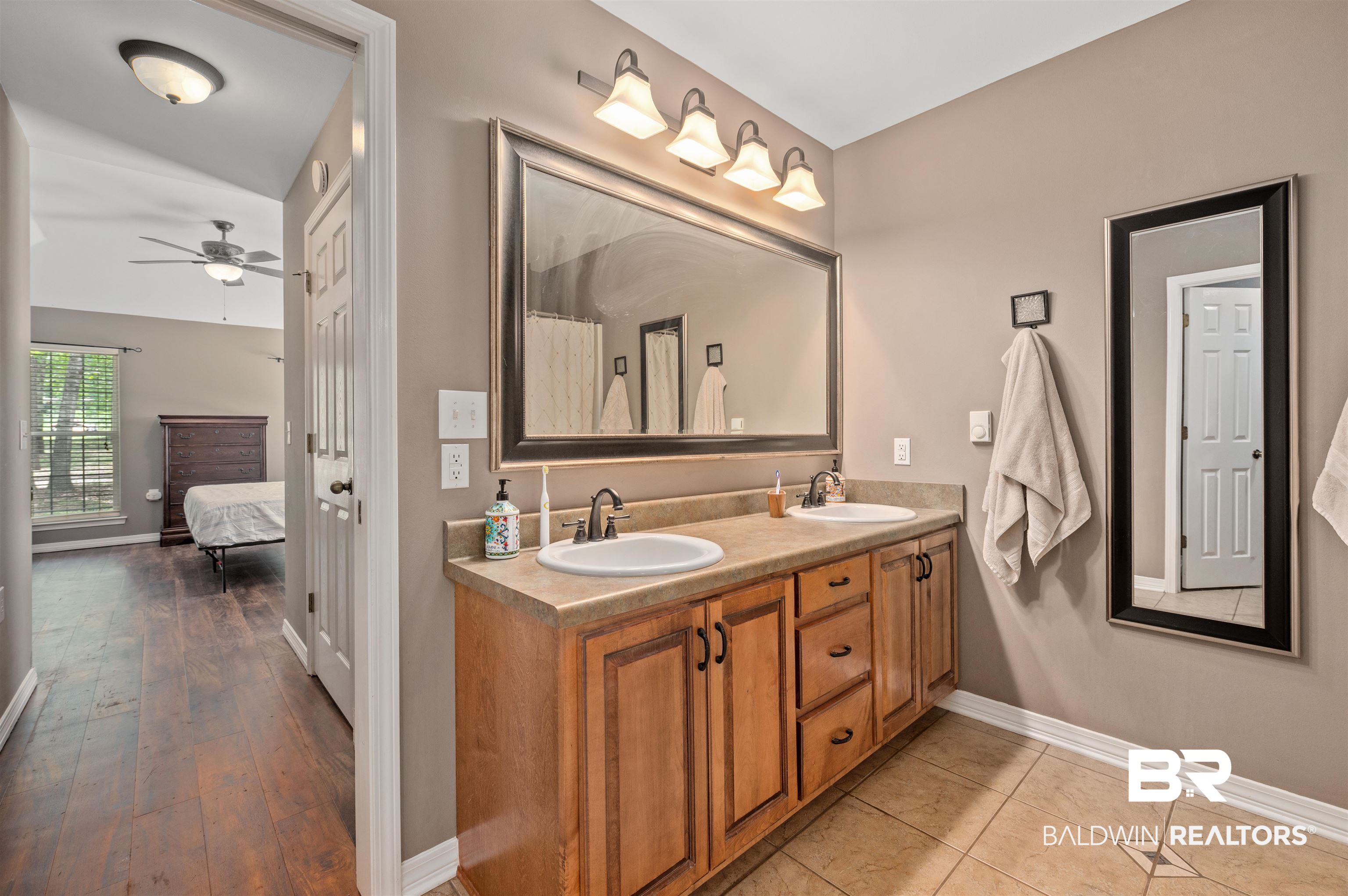 15240 Styx River Road Stapleton, AL 36578 - Photo 8 of 18 Bathroom featuring vanity, hardwood / wood-style flooring, and ceiling fan