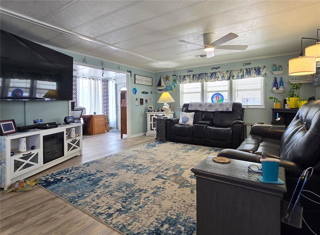 5619 Bayshore Road, Unit 435 Palmetto, FL 34221 - Photo 11 of 56 a living room with furniture a flat screen tv and kitchen view