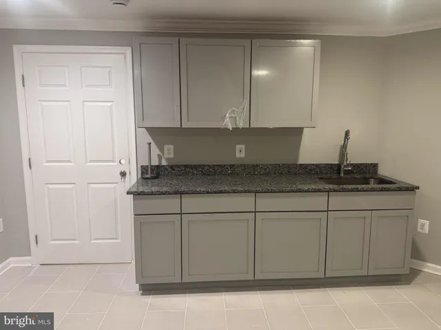 a view of a kitchen with a sink and cabinet
