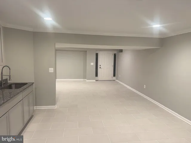 a large kitchen with stainless steel appliances a sink a stove a microwave and cabinets