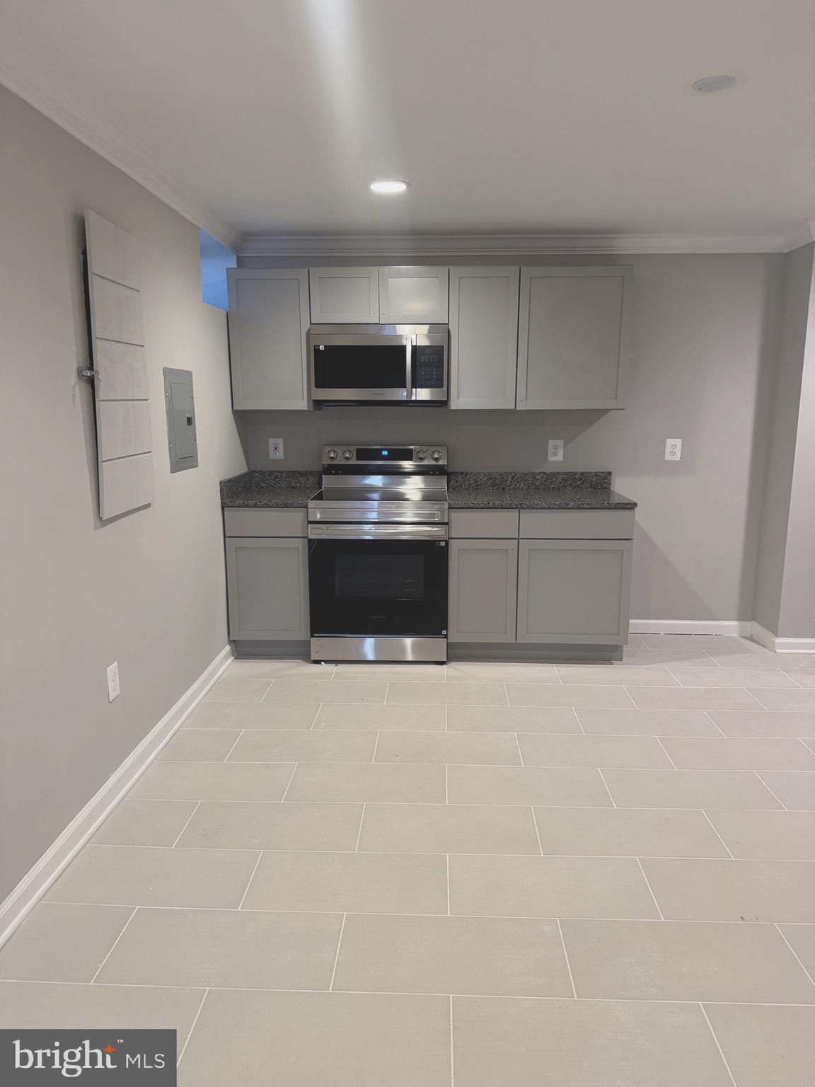 5890 Tulloch Spring Court Haymarket, VA 20169 - Photo 14 of 15 a large kitchen with stainless steel appliances a sink a stove a microwave and cabinets