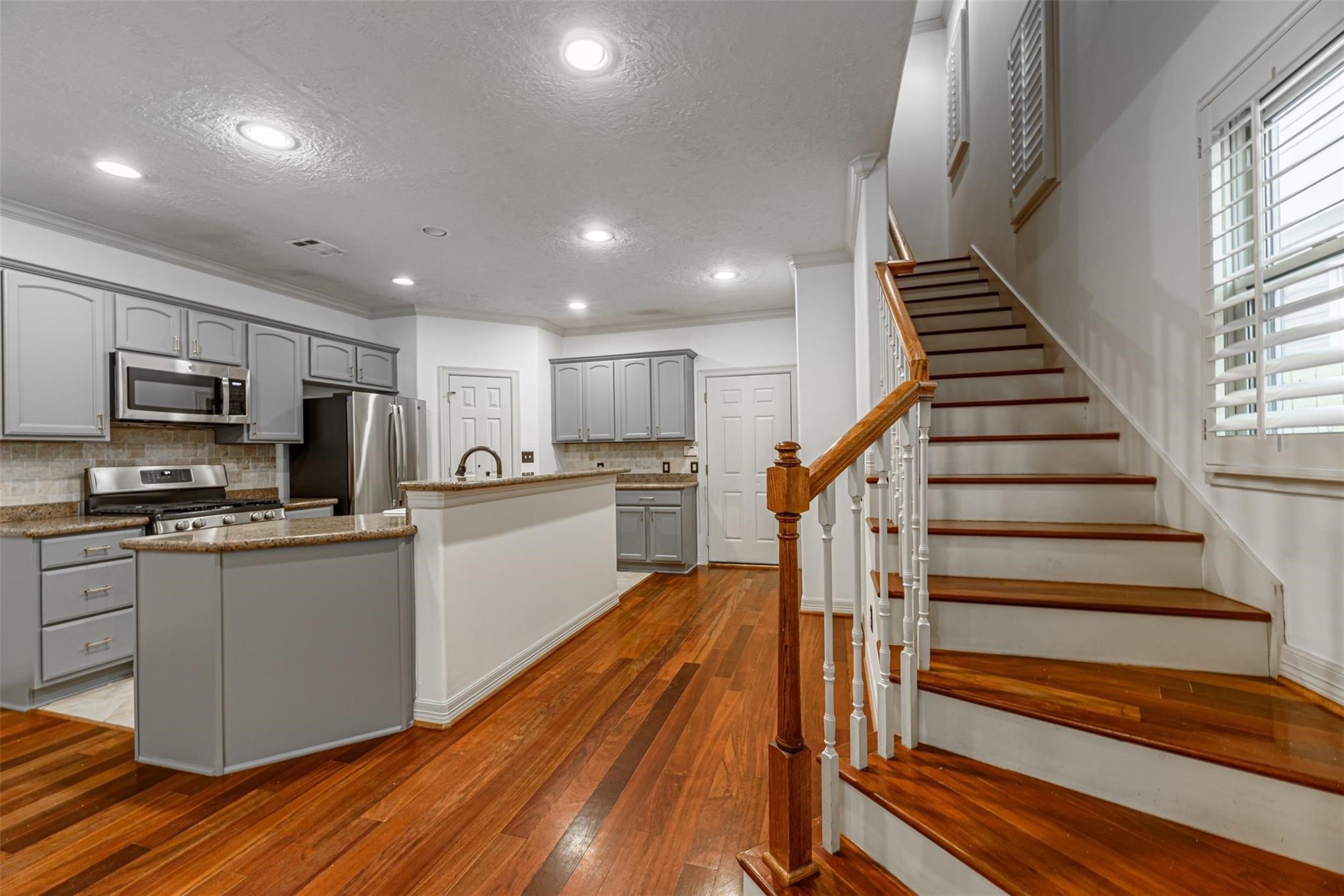 1324 Prince Street Houston, TX 77008 - Photo 12 of 26 a kitchen with wooden floors stainless steel appliances and window