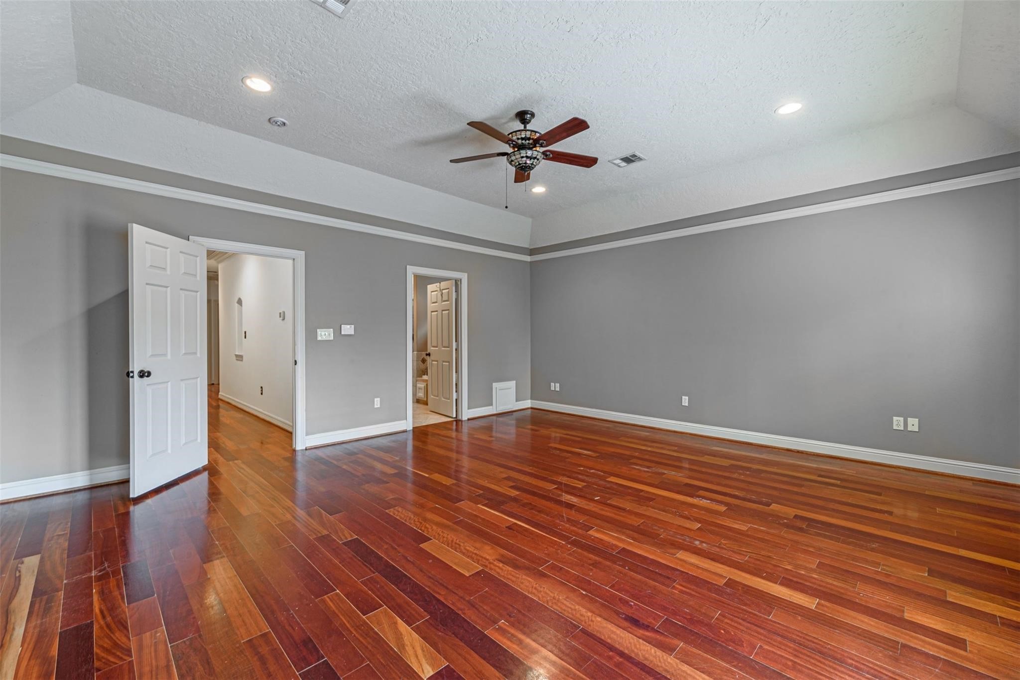 1324 Prince Street Houston, TX 77008 - Photo 19 of 26 a view of an empty room with wooden floor and a ceiling fan