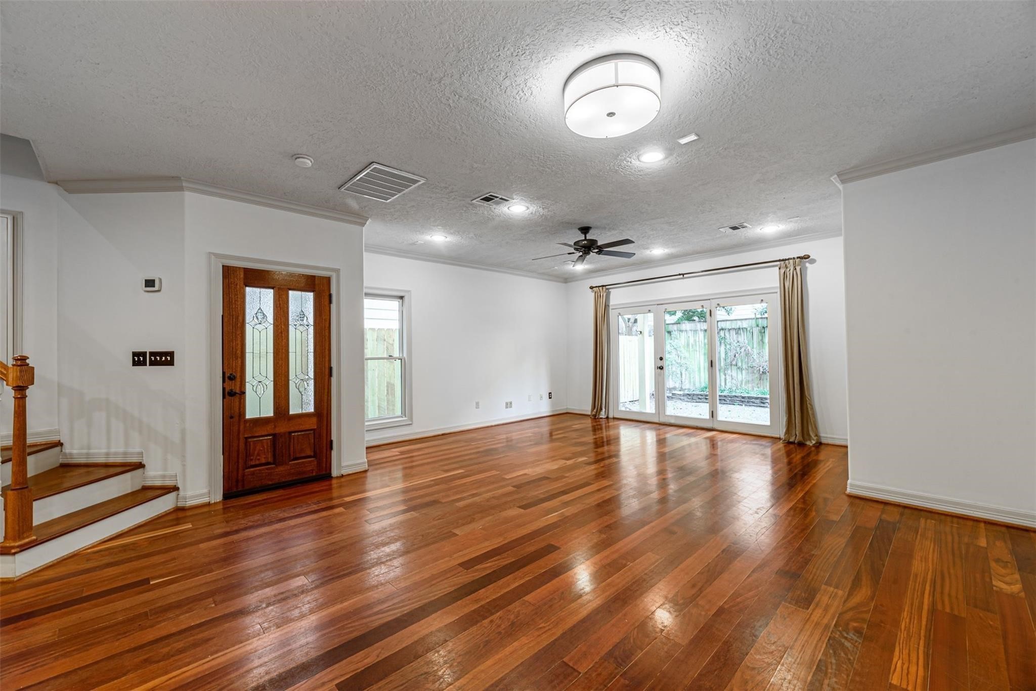 1324 Prince Street Houston, TX 77008 - Photo 3 of 26 a view of an empty room with wooden floor and a window