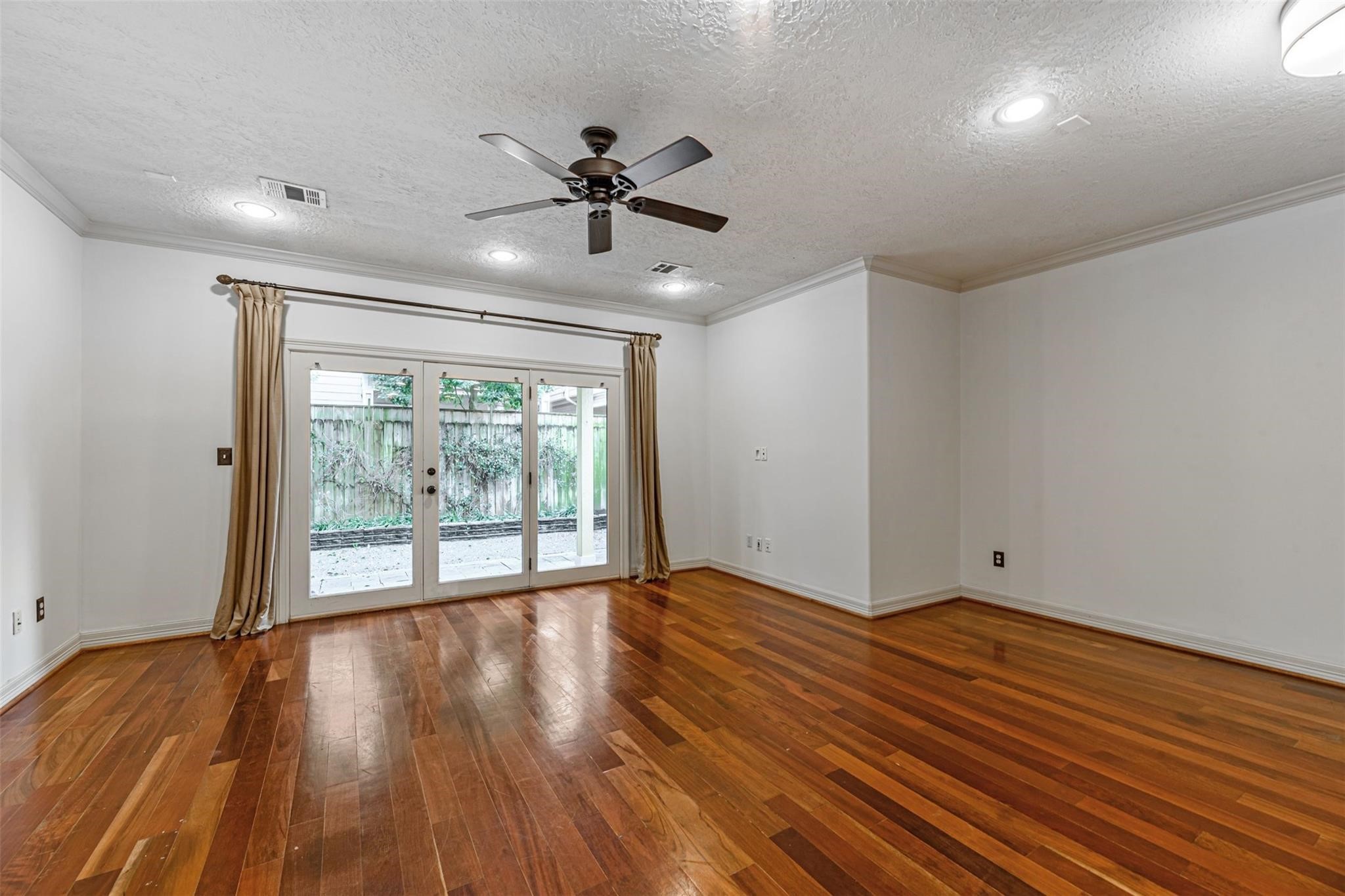 1324 Prince Street Houston, TX 77008 - Photo 4 of 26 a view of an empty room with wooden floor and a window