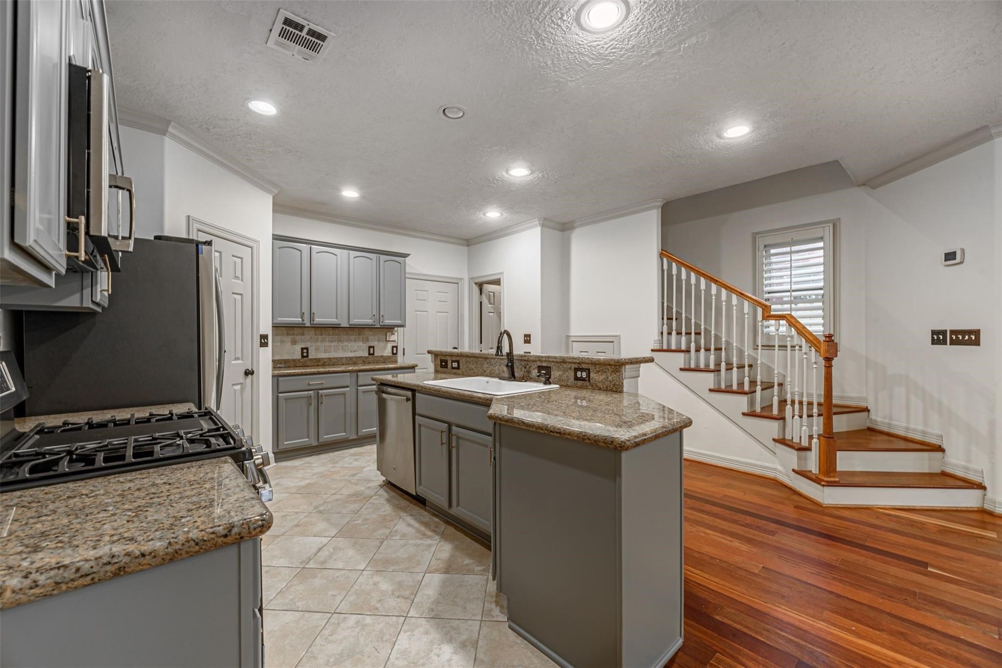 1324 Prince Street Houston, TX 77008 - Photo 7 of 26 a kitchen with stainless steel appliances granite countertop a sink stove and refrigerator