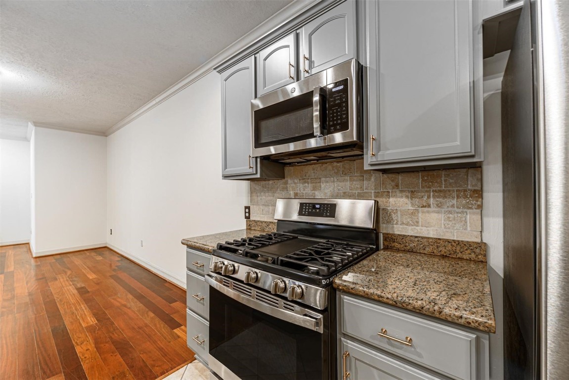 1324 Prince Street Houston, TX 77008 - Photo 8 of 26 a kitchen with stainless steel appliances granite countertop a stove and a microwave