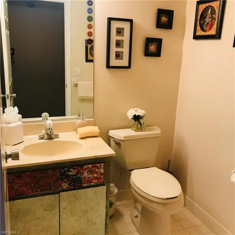 a bedroom with a bed table and a window