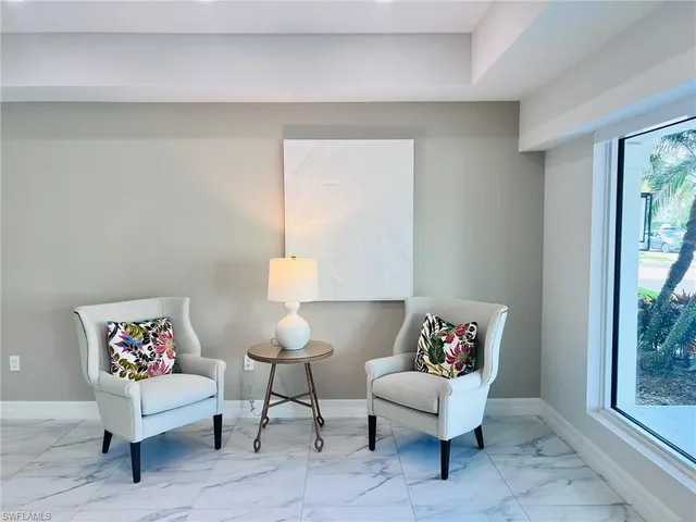 a living room with furniture potted plant and a window