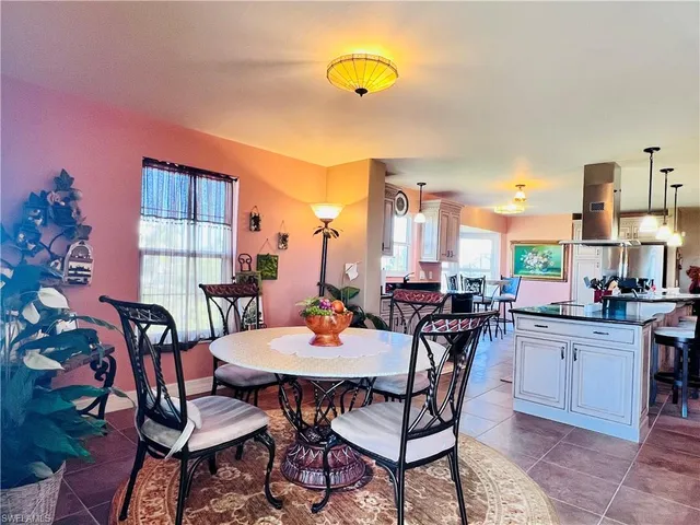 a view of a dining room with furniture a rug and wooden floor