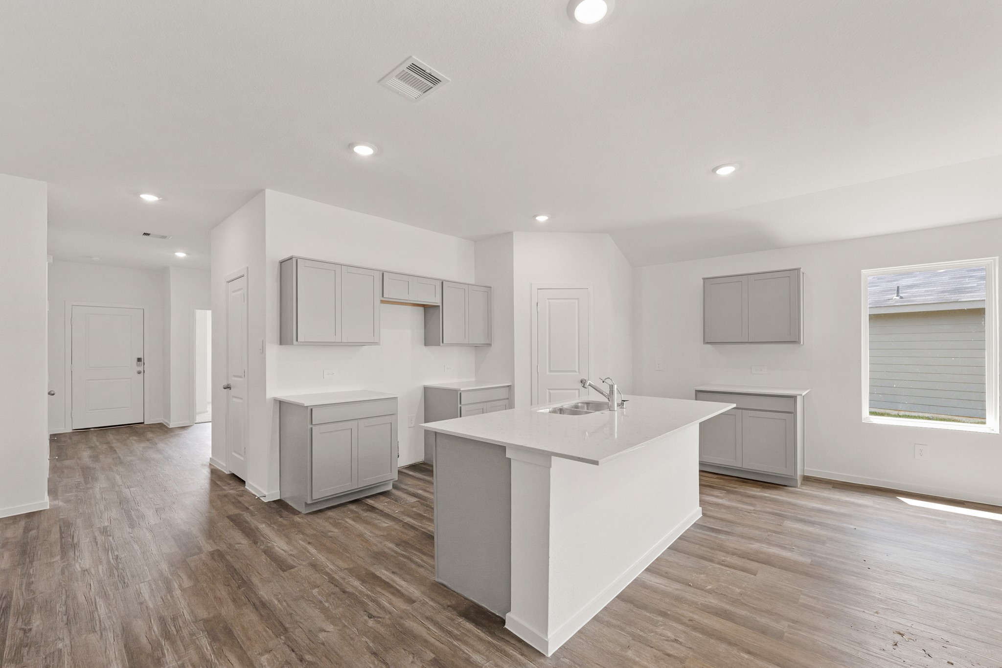 553 Wax Myrtle Way Hockley, TX 77447 - Photo 2 of 18 a large white kitchen with a white countertops a stove and a wooden floors