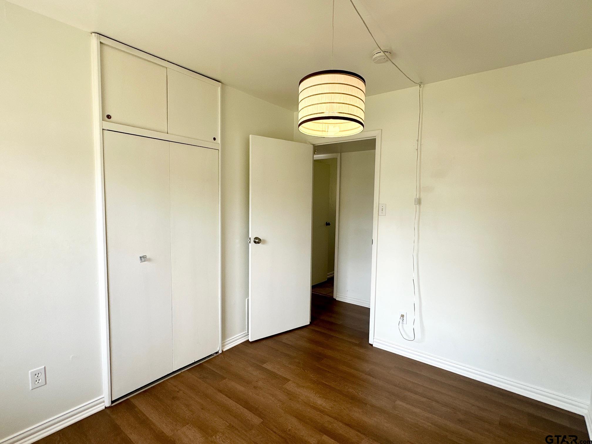 2412 East Devine Street Tyler, TX 75701 - Photo 13 of 27 a view of a livingroom with wooden floor and a gate