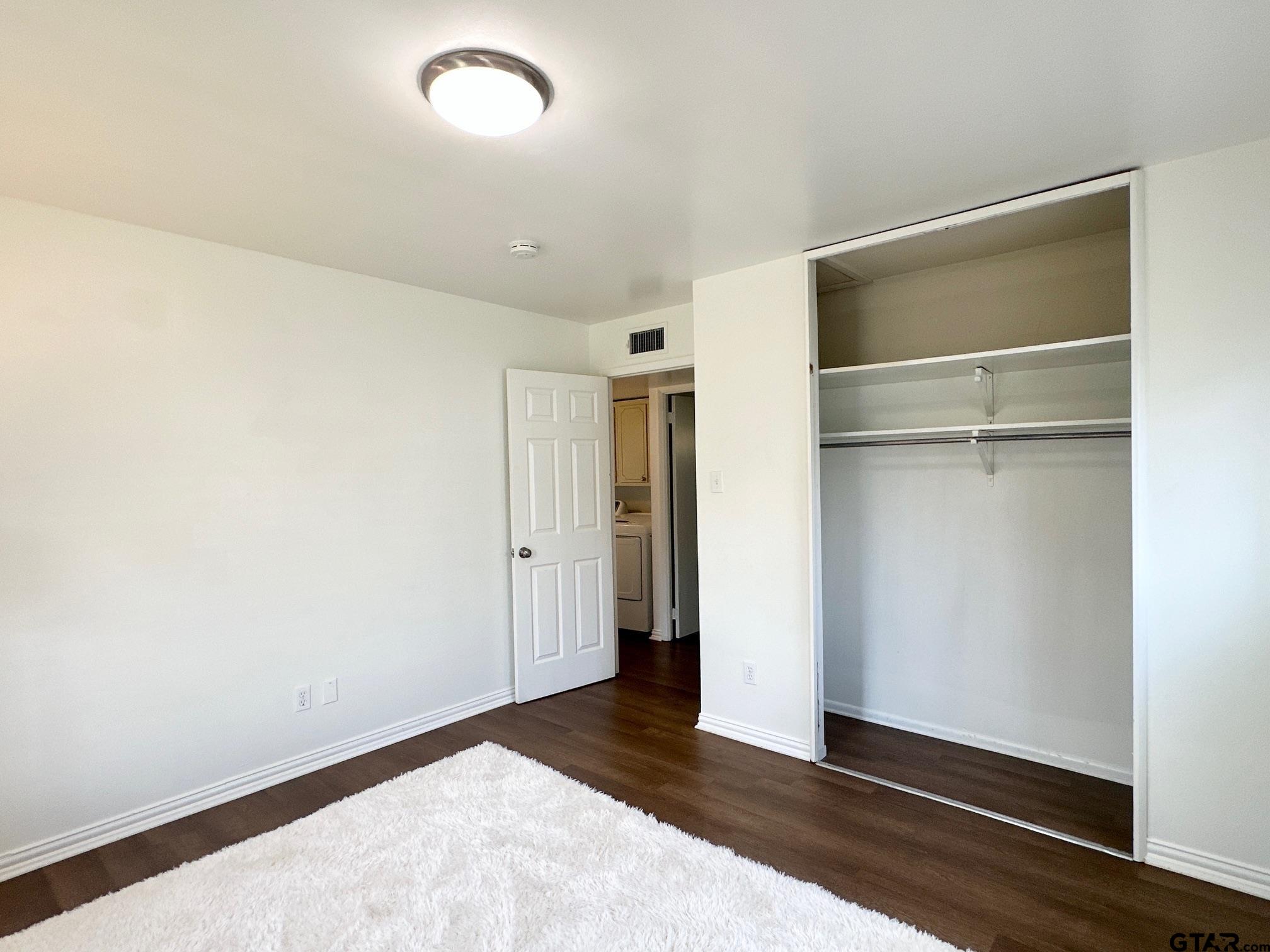 2412 East Devine Street Tyler, TX 75701 - Photo 17 of 27 a view of an empty room with closet and a window