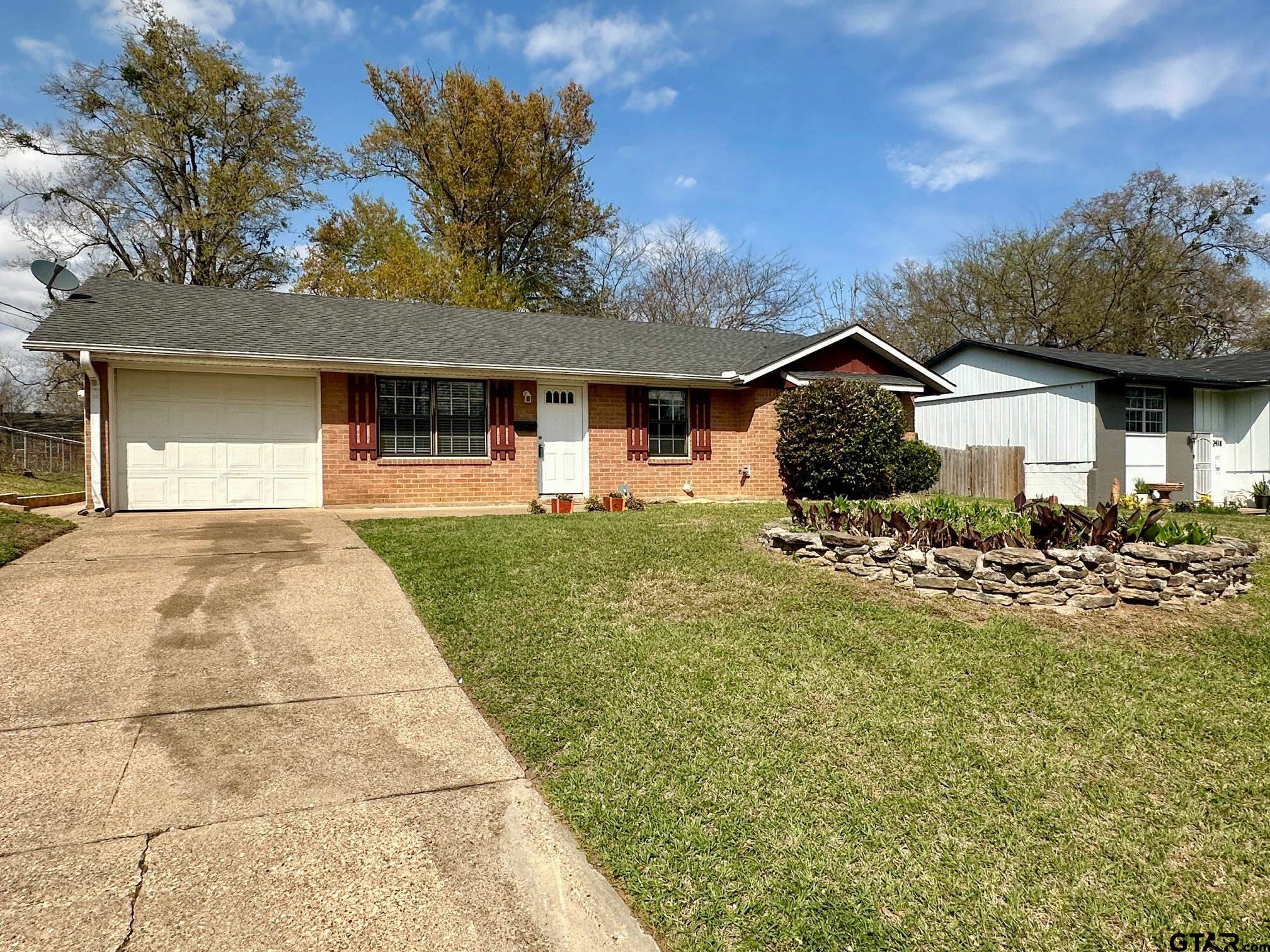 2412 East Devine Street Tyler, TX 75701 - Photo 3 of 27 a front view of a house with garden
