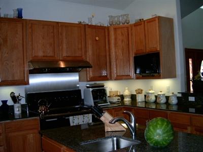 7425 Sharp Road Calistoga, CA 94515 - Photo 3 of 8 a kitchen with granite countertop a refrigerator and a stove top oven