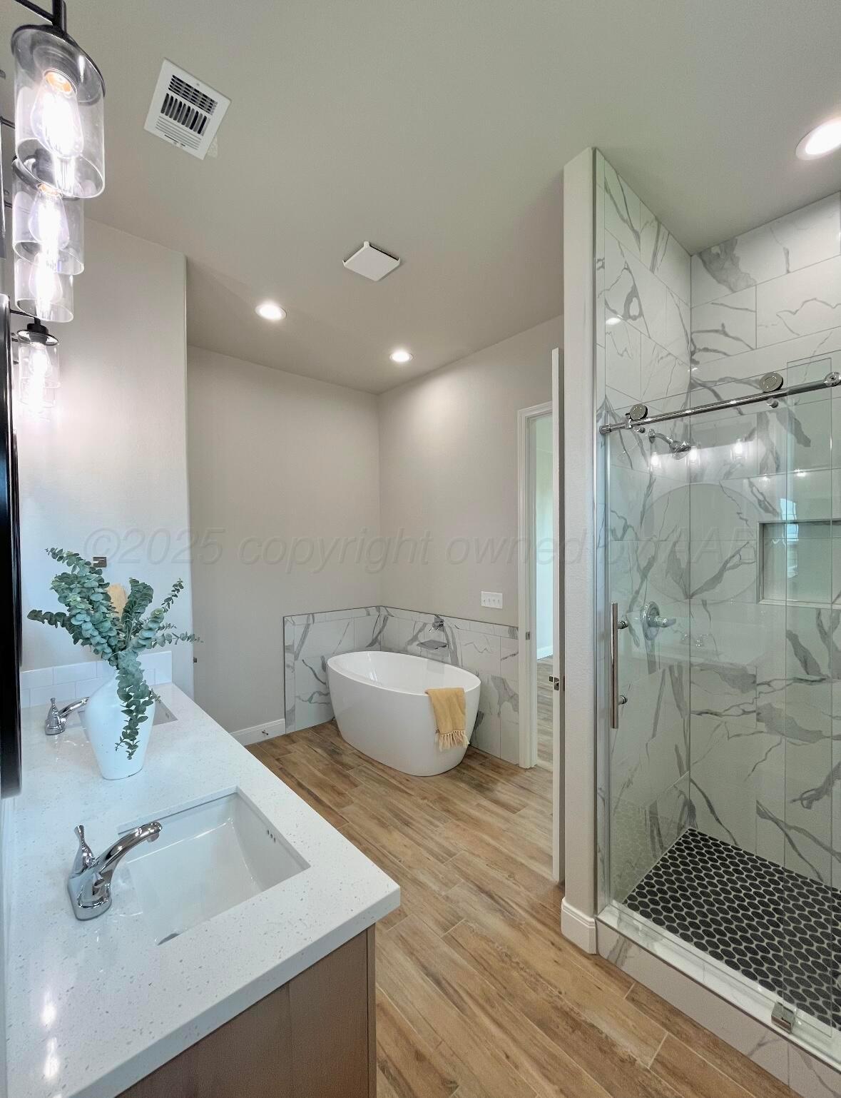 7504 Limestone Drive Amarillo, TX 79119 - Photo 12 of 12 a bathroom with a sink a toilet and shower