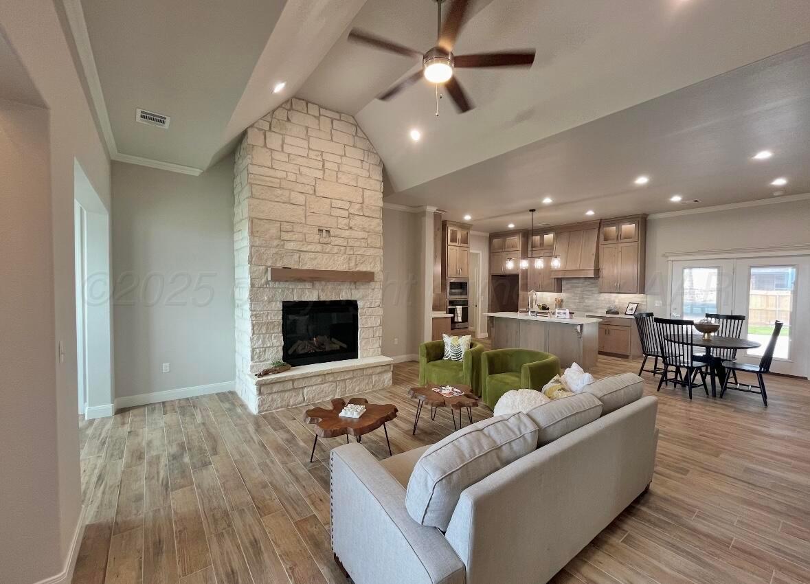 7504 Limestone Drive Amarillo, TX 79119 - Photo 3 of 12 a living room with furniture and a fireplace