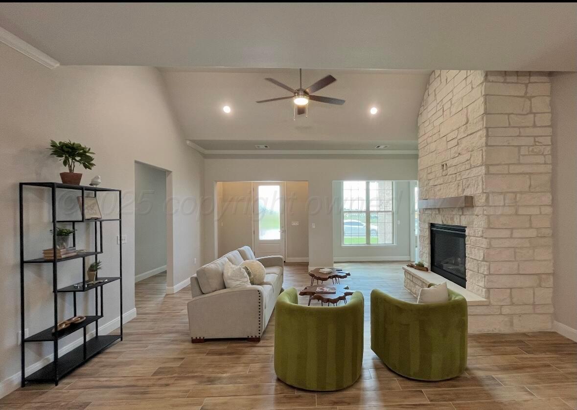7504 Limestone Drive Amarillo, TX 79119 - Photo 4 of 12 a living room with furniture and a fireplace