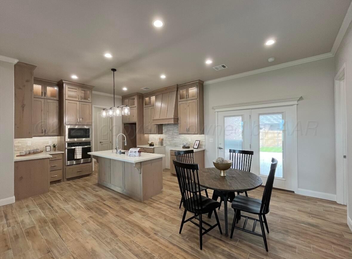 7504 Limestone Drive Amarillo, TX 79119 - Photo 5 of 12 a kitchen with a table and chairs in it