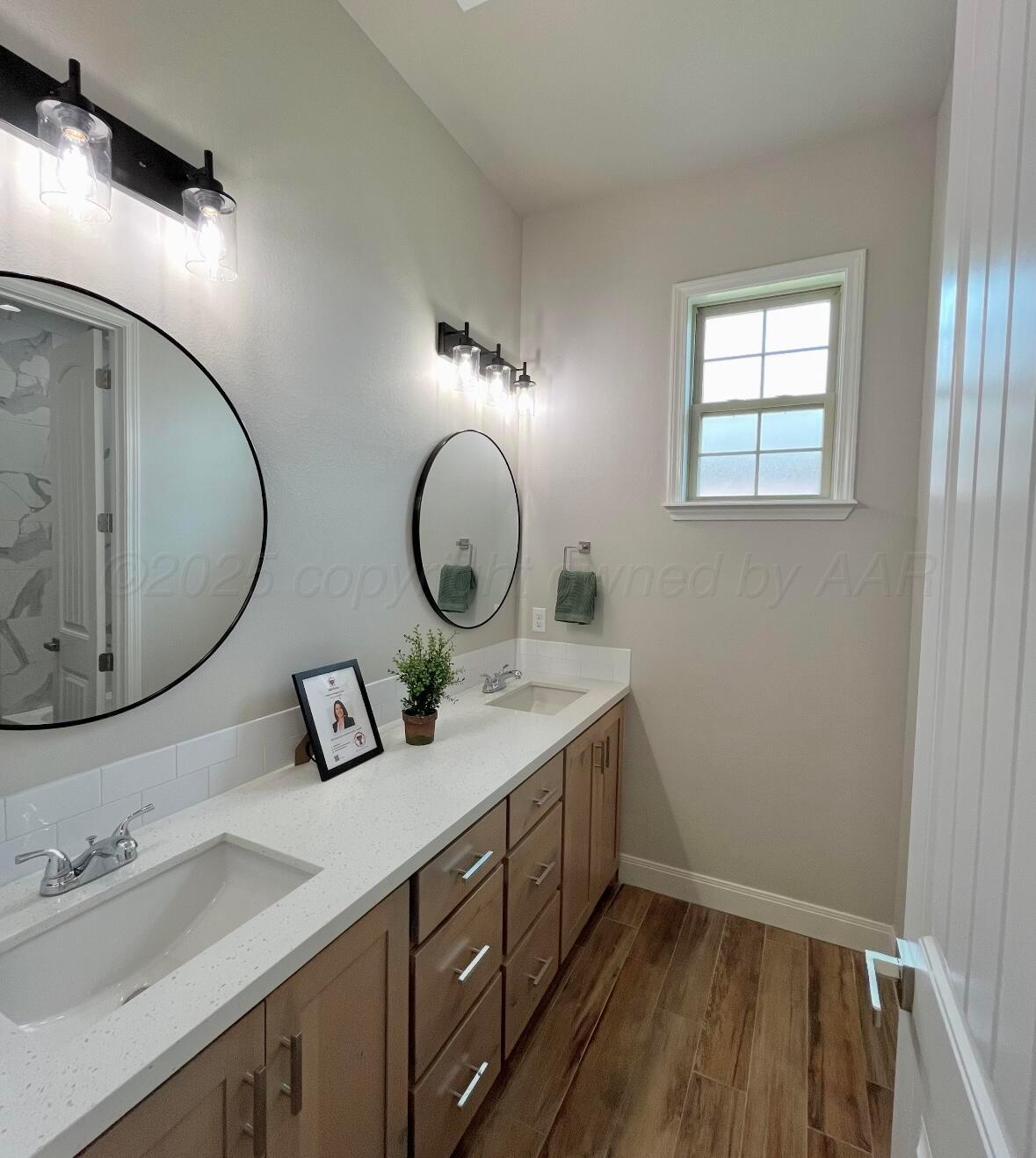 7504 Limestone Drive Amarillo, TX 79119 - Photo 7 of 12 a bathroom with a double vanity sink and a mirror