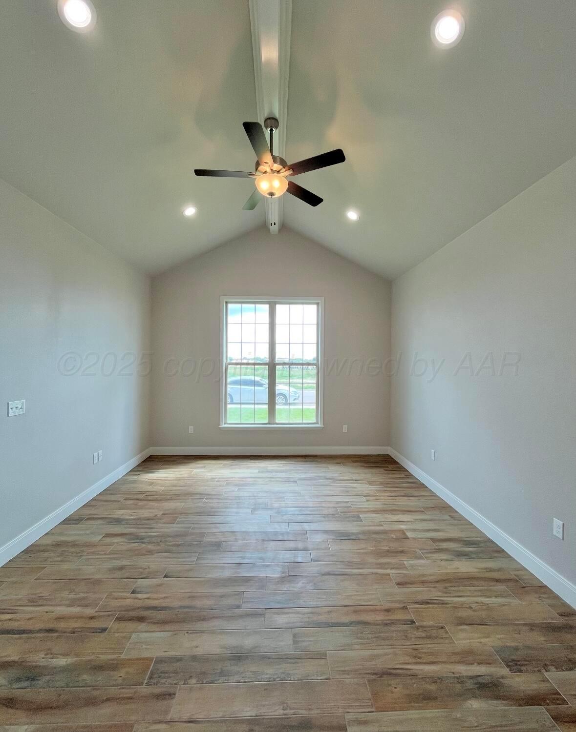 7504 Limestone Drive Amarillo, TX 79119 - Photo 10 of 12 wooden floor in an empty room with a window
