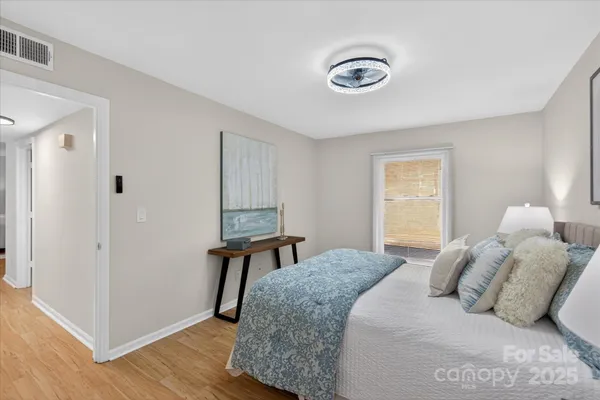 a bedroom with a bed and a chandelier
