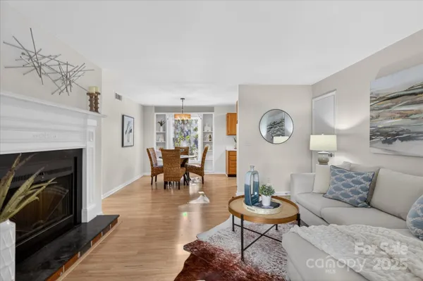 a living room with furniture a clock and a fireplace