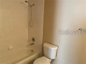 a bathroom with a toilet and shower