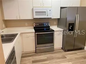 a kitchen with a stove cabinets and refrigerator
