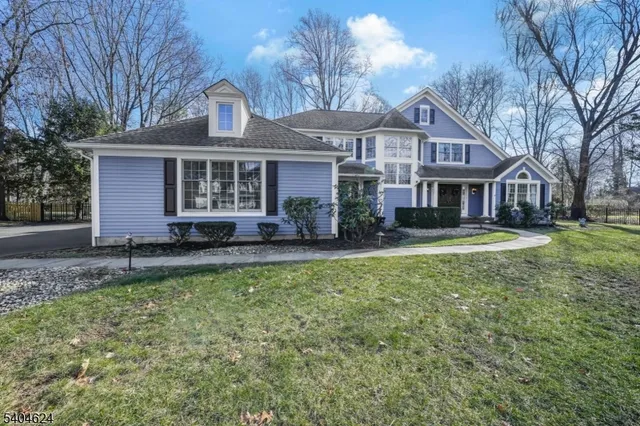 a front view of a house with a yard and trees