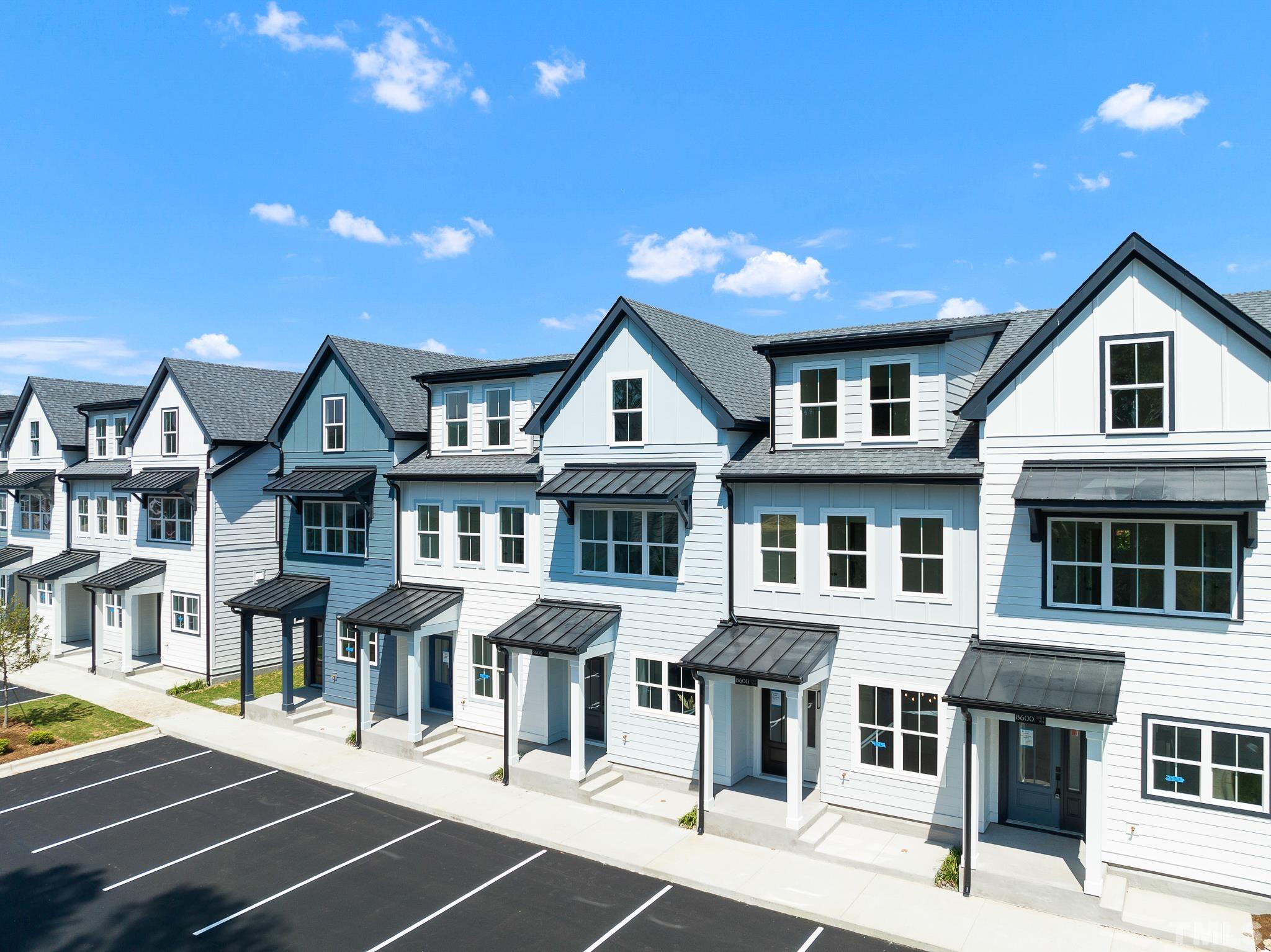 a front view of residential houses with yard