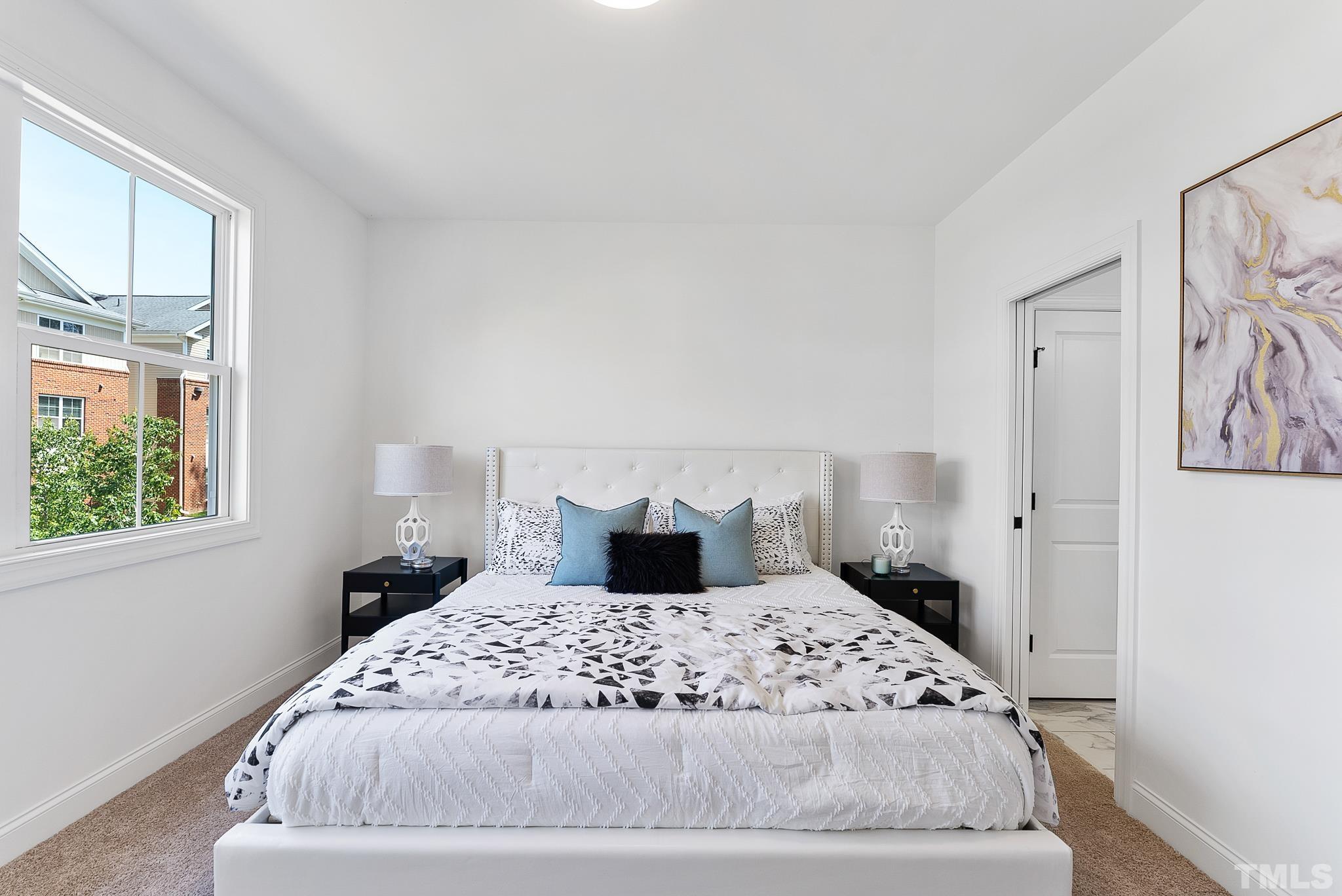 8610 Brushfoot Way, Unit 101 Raleigh, NC 27616 - Photo 18 of 42 a bedroom with a large bed and a window