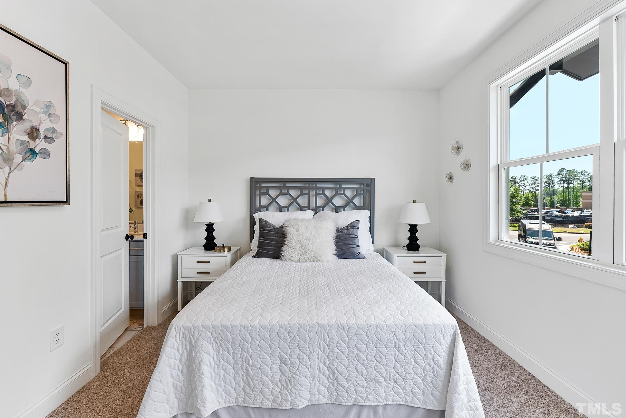 8610 Brushfoot Way, Unit 101 Raleigh, NC 27616 - Photo 21 of 42 a bedroom with a bed and a large window