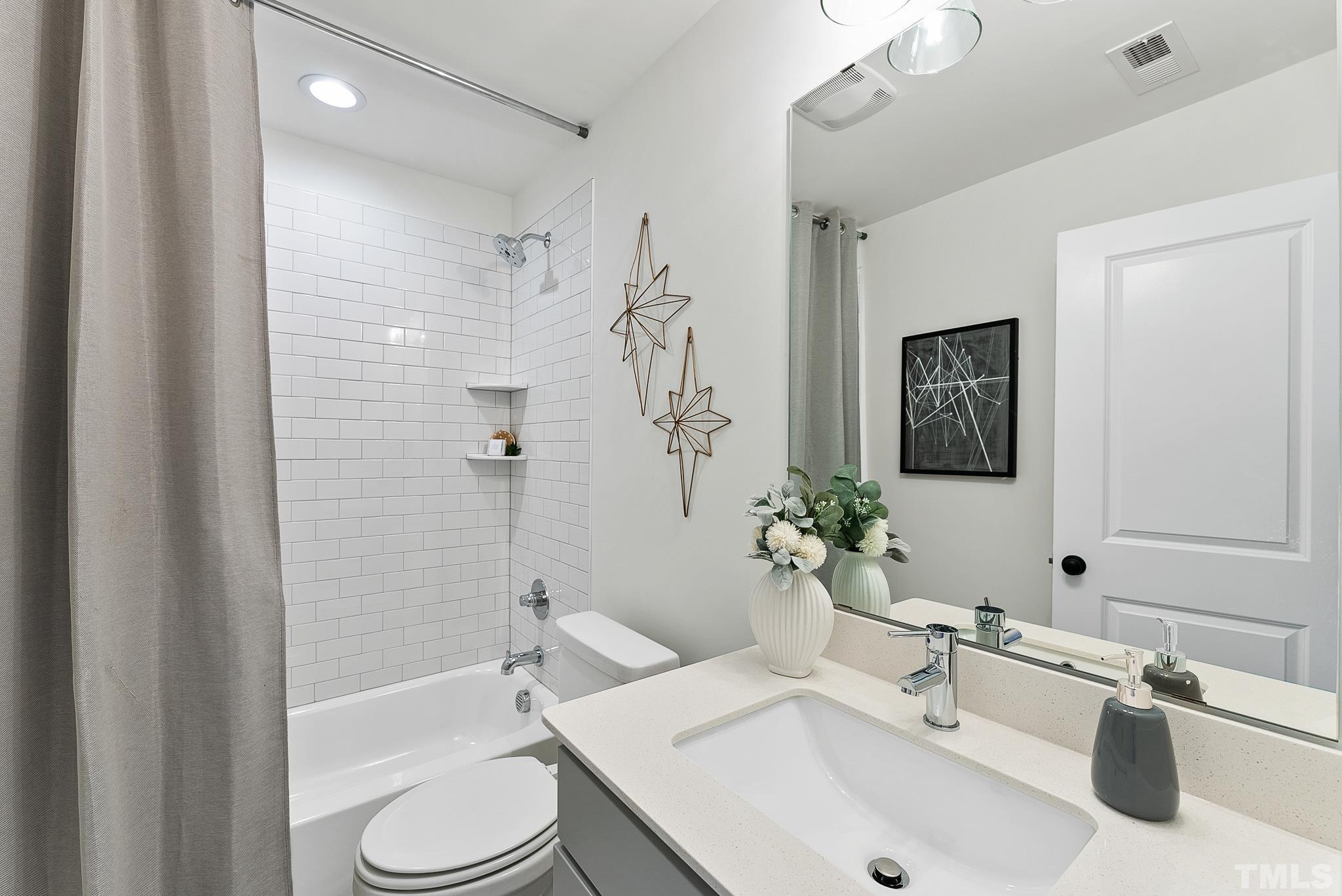 8610 Brushfoot Way, Unit 101 Raleigh, NC 27616 - Photo 27 of 42 a bathroom with a sink toilet and shower
