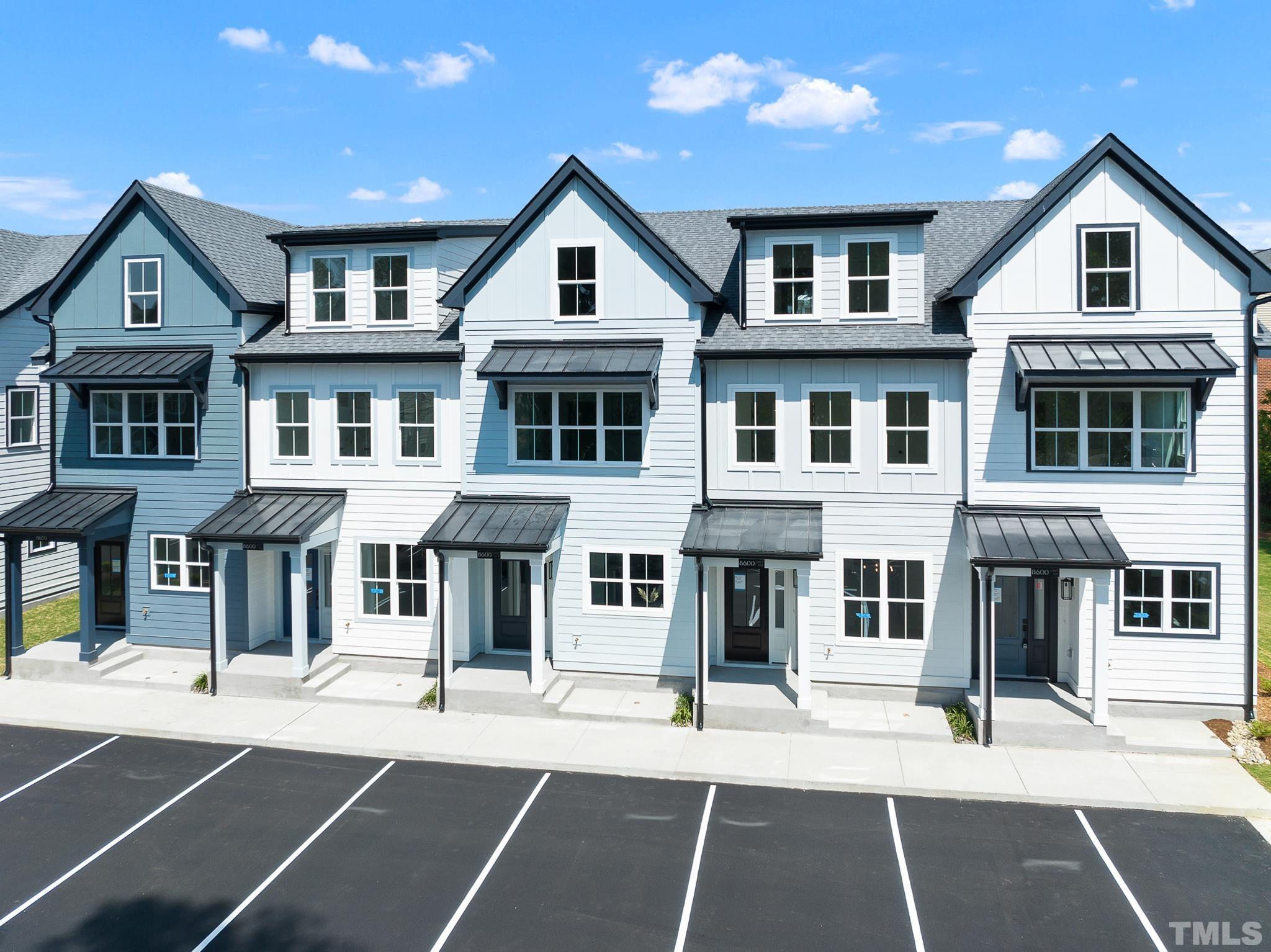 8610 Brushfoot Way, Unit 101 Raleigh, NC 27616 - Photo 31 of 42 a front view of a residential apartment building with a yard