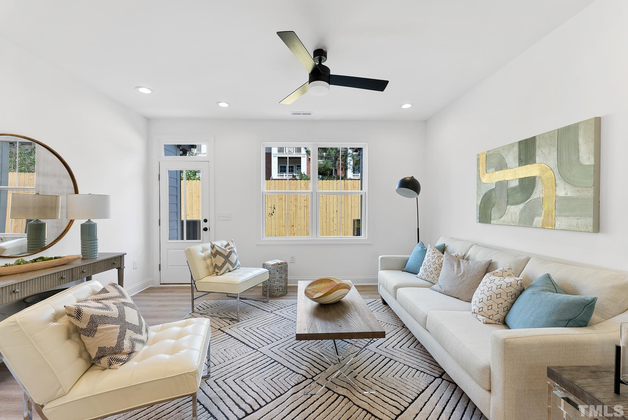 8610 Brushfoot Way, Unit 101 Raleigh, NC 27616 - Photo 4 of 42 a living room with furniture and a flat screen tv