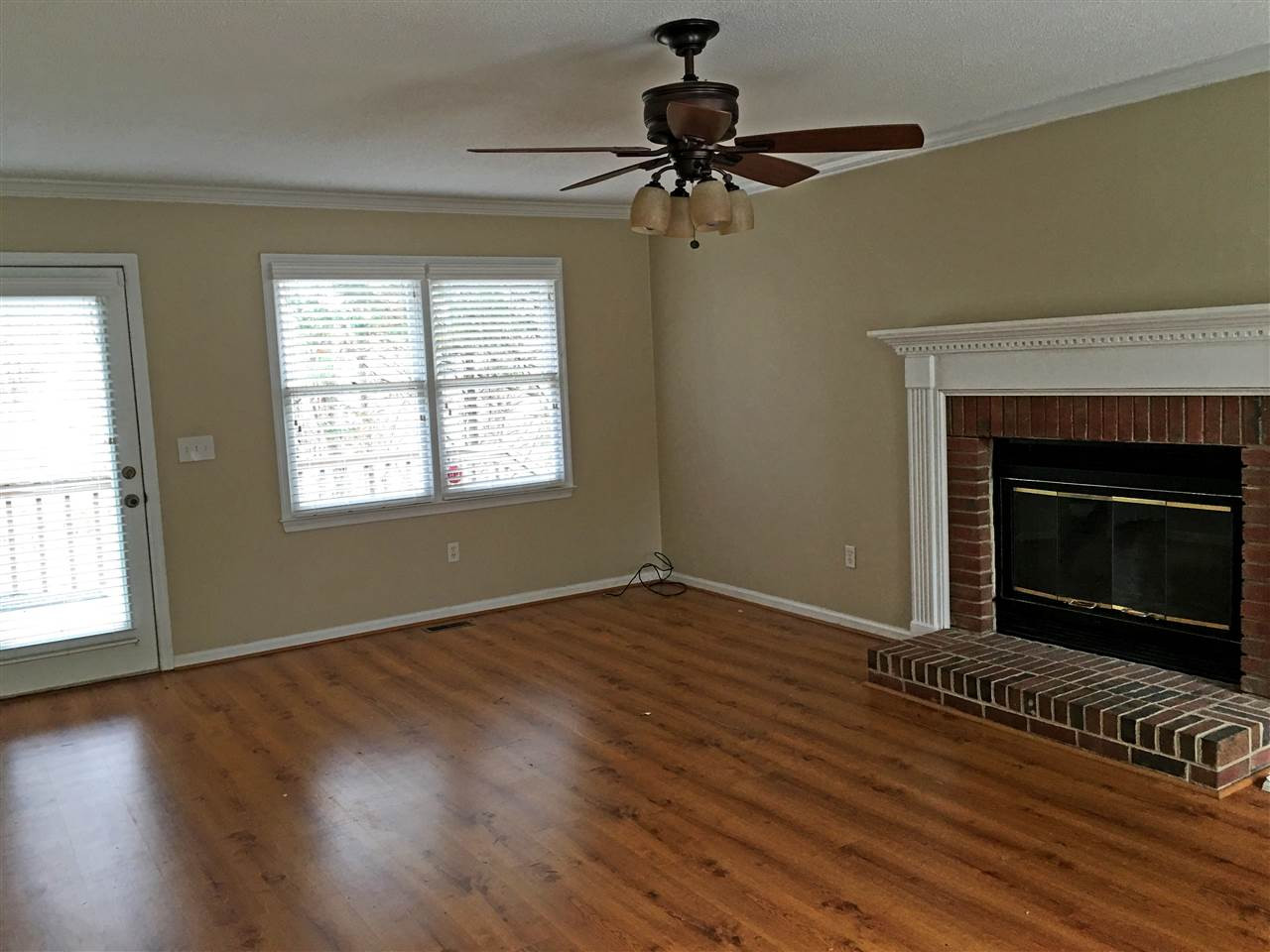 2 Hitching Rack Court Durham, NC 27713 - Photo 6 of 23 Large living room with wide plank laminate floor and wood burning fireplace with raised brick hearth. Living Room