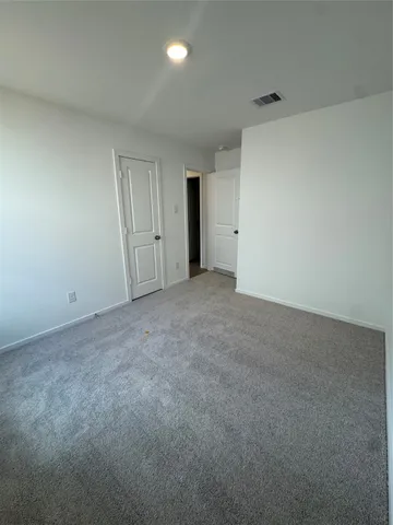 a view of an empty room and closet area