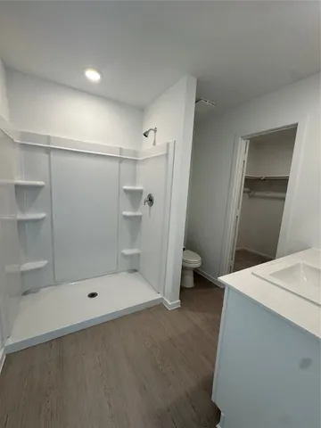 a bathroom with a shower and a sink