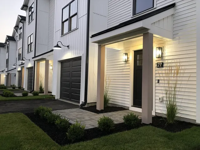 a view of a brick house with many windows