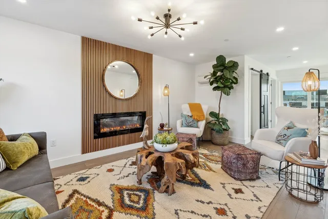 a living room with furniture potted plant and a fireplace