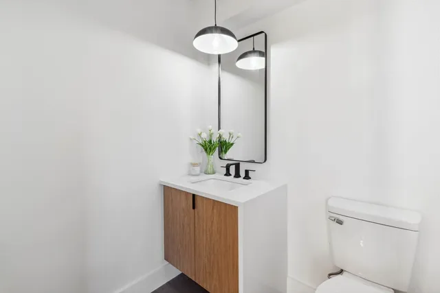 a bathroom with a light fixture a mirror and a shower