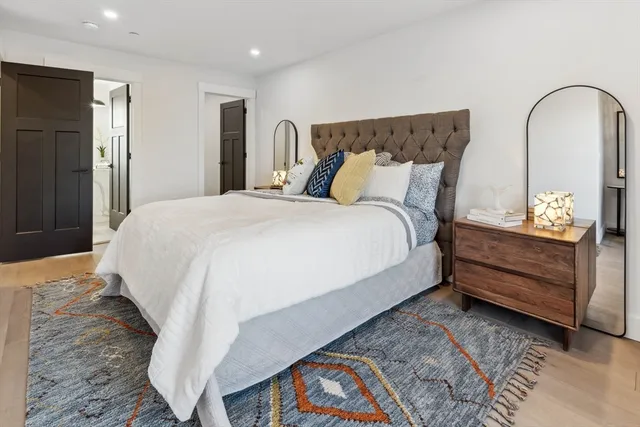 a bed sitting in a bedroom next to a window